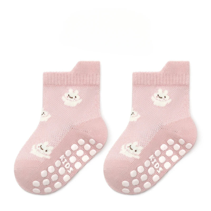 Pair of non-slip baby floor socks in pink with bunny print and grippy toe dots