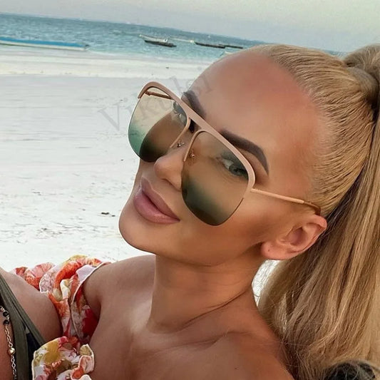 Oversized square sunglasses with brown frame and dark green-tinted lenses