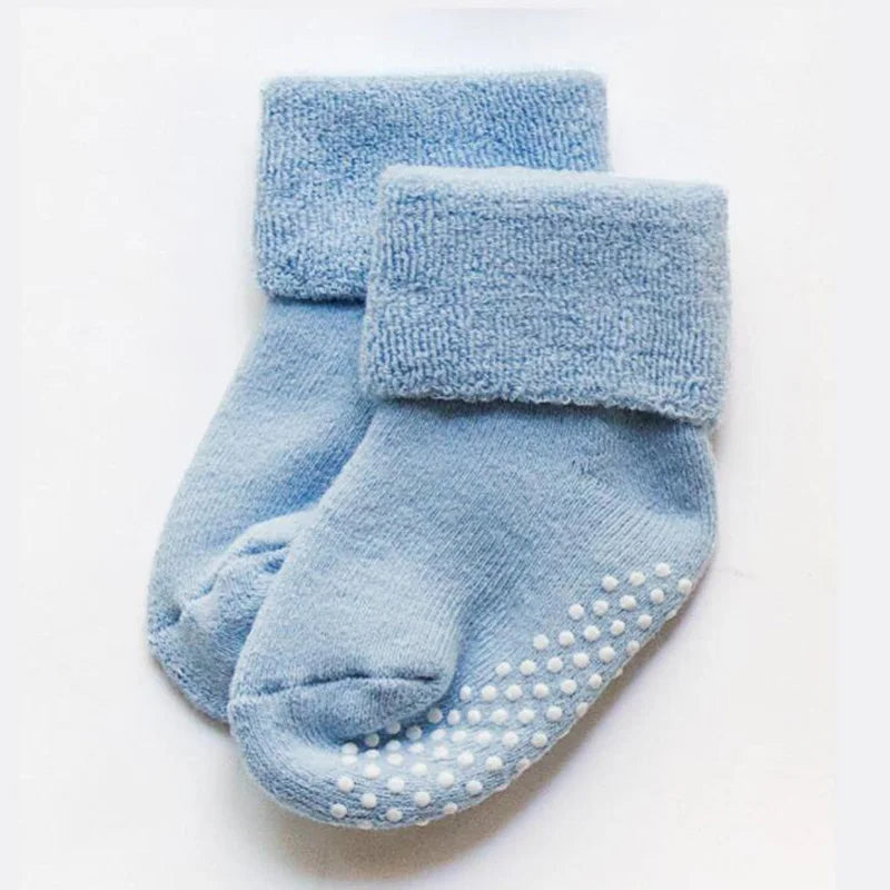 Thick winter baby socks, light blue pair with cushioned cuffs and grip dots on sole