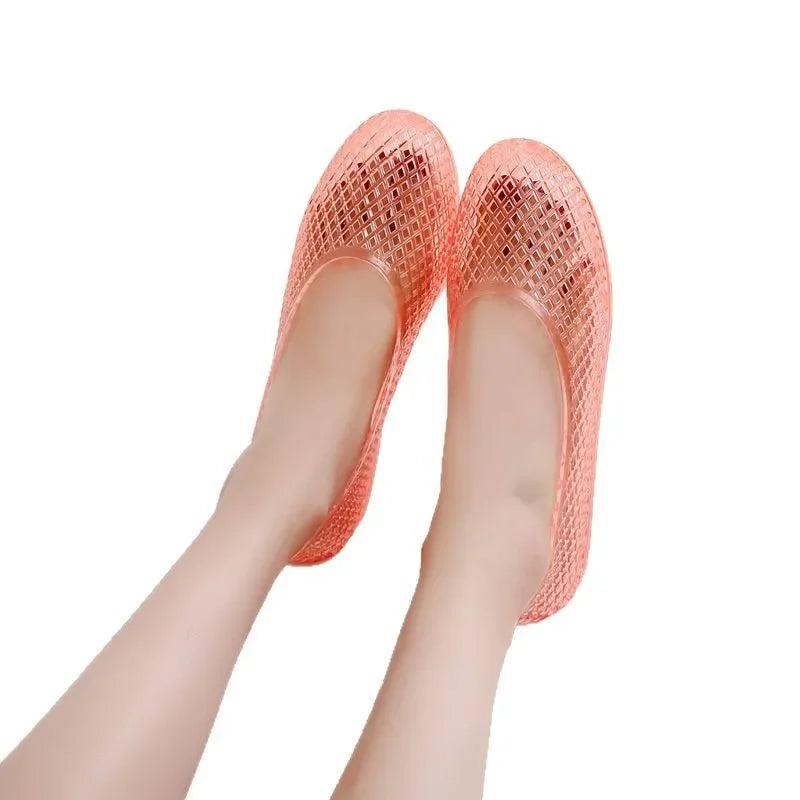 Pink jelly shoes with textured translucent upper, slip-on style