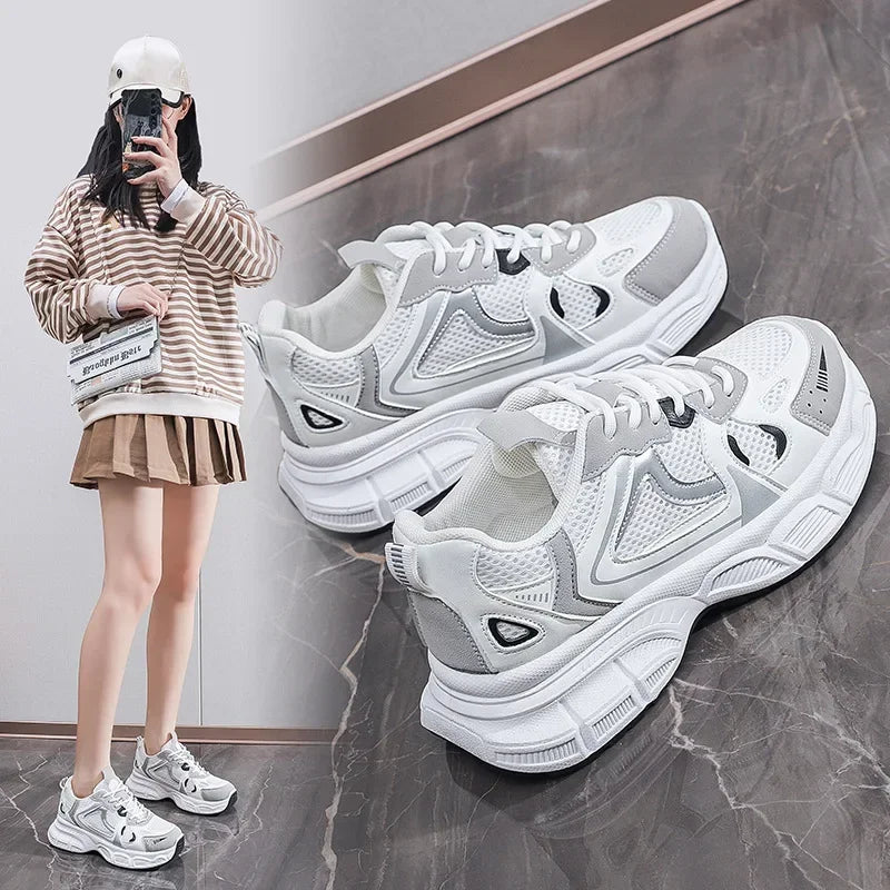 White chunky platform sneakers with lace-up front and chunky sole, angled pair