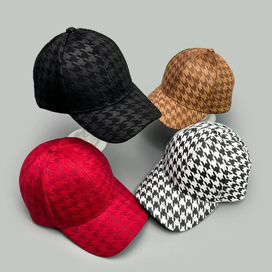 Three baseball caps with houndstooth patterns in black, brown, and white and red colors.