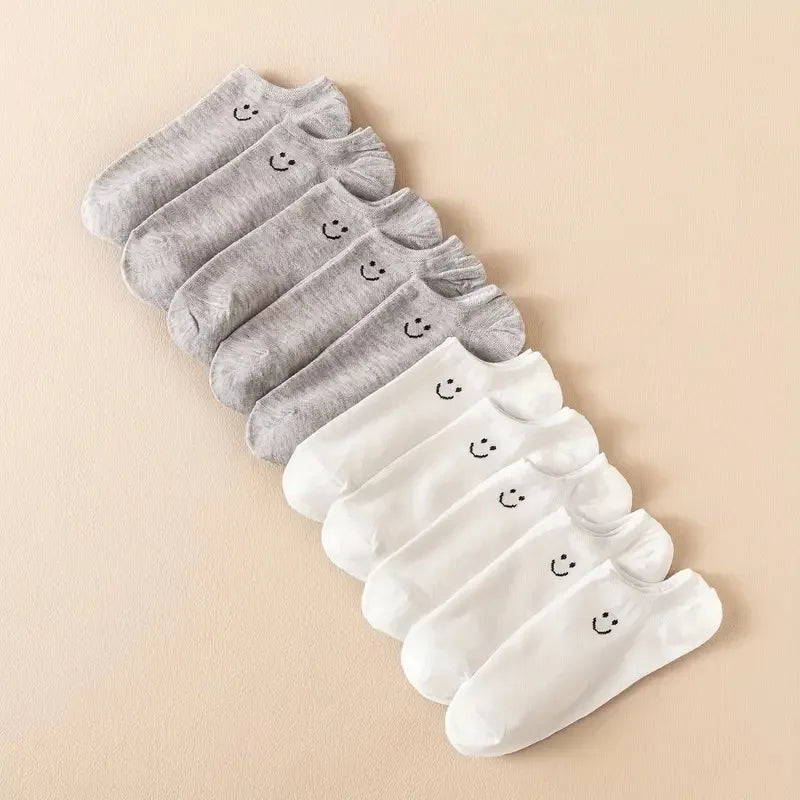 Women’s no-show socks multipack in grey and white with smiley face accents.