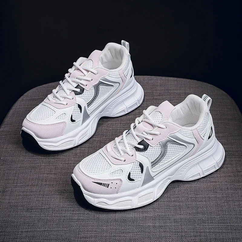 White chunky platform sneakers with pink side panels and lace-up closure, pair