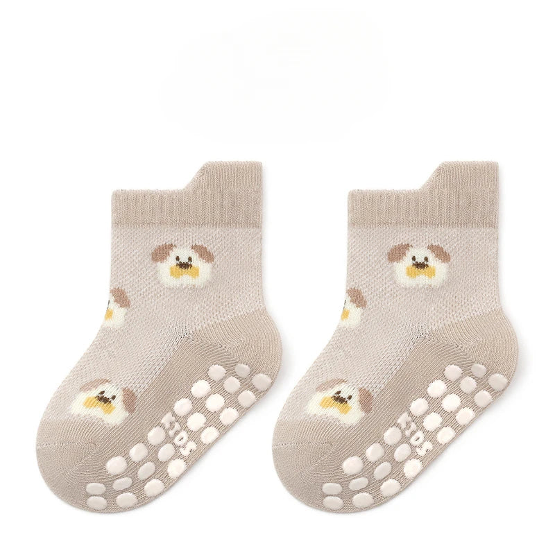 Pair of non-slip baby floor socks in beige with chick print and grippy toe dots