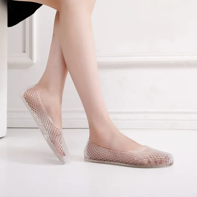 Light pink clear jelly shoes slip-on flats with textured grid upper and rounded toe