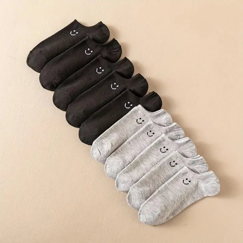 Women’s no-show socks multipack in black and grey with smiley face accents.