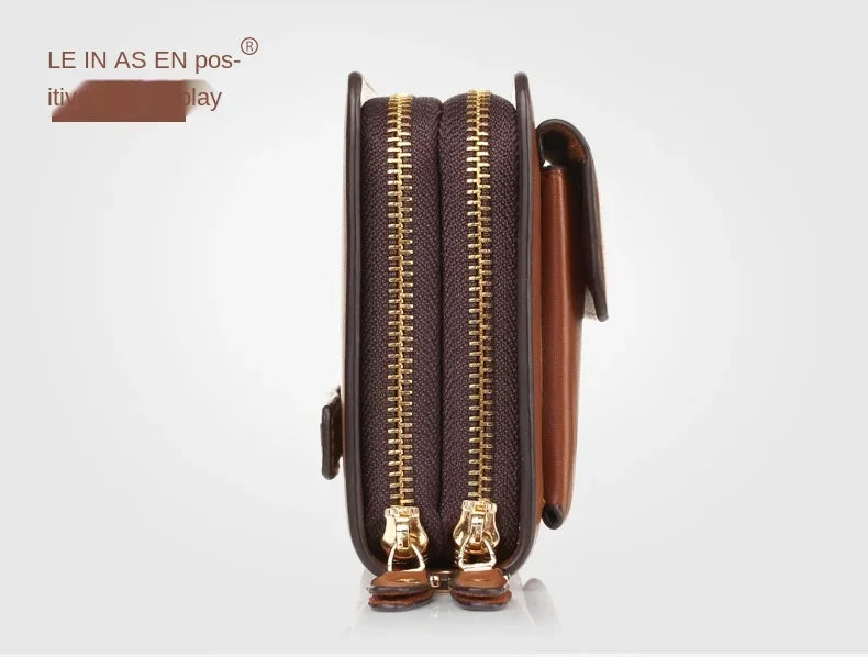 Brown leather wallet open view showing two zipper compartments and gold pulls