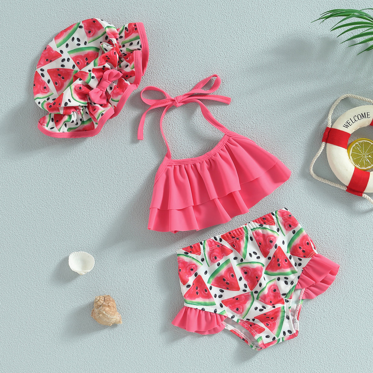 Toddler ruffle bikini set with pink halter top, watermelon print bottoms, and hat