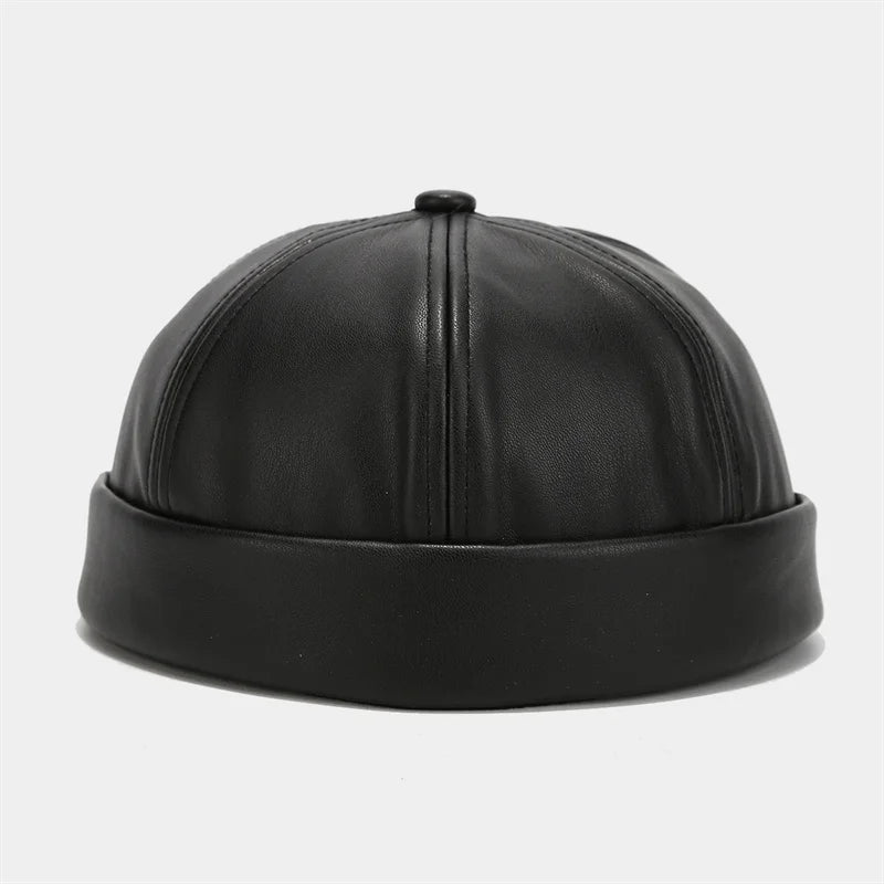 Black PU leather docker cap with stitched crown panels and small top button.