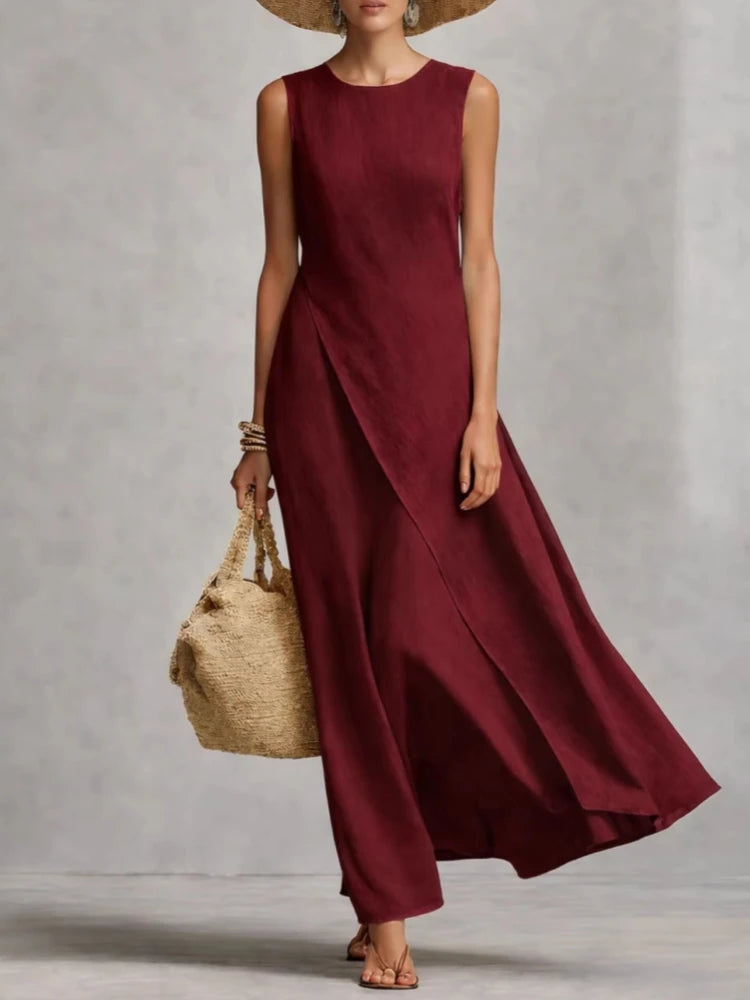 Burgundy sleeveless maxi dress with draped front wrap and wide flared skirt