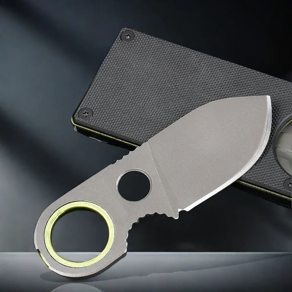 Folding pocket knife keychain with dark grip, stainless blade, and green ring
