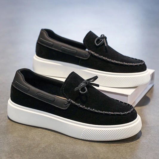 Men's black suede dress loafers with metal ring detail and white textured sole