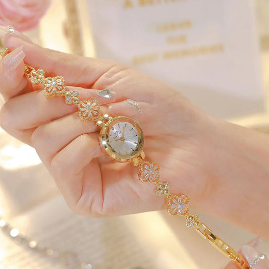 Golden crystal-accent bracelet watch with round white dial and floral link band
