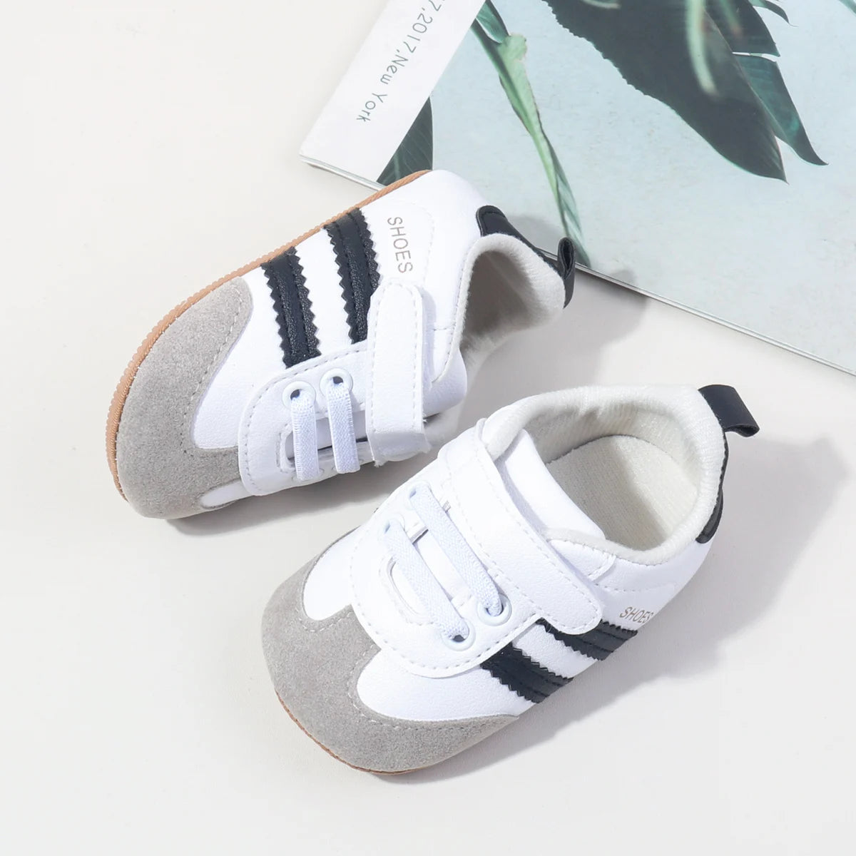 Baby first walker sneakers, white upper with gray panels and hook-and-loop strap