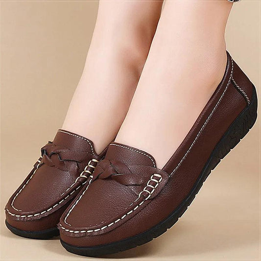 Women's brown leather loafers with braided detail and white contrast stitching.