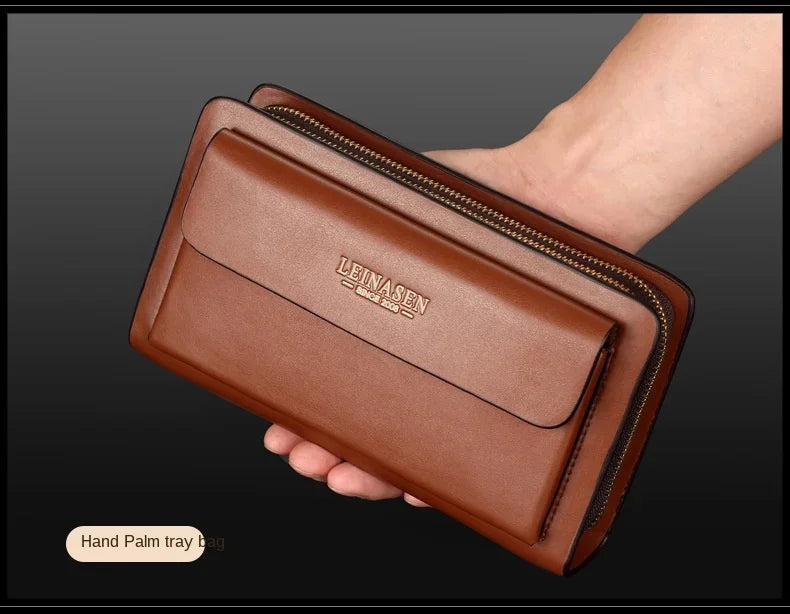 Brown double-zip wallet clutch with front money clip pocket, held in hand