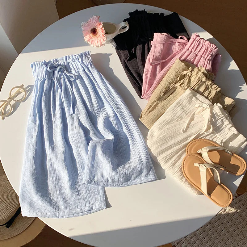 Assorted toddler summer pants in light blue, black, pink, and beige with drawstring waist