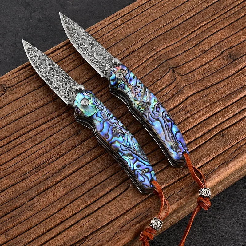 Damascus steel folding knife with iridescent blue handle, silver damascus blade, lanyard