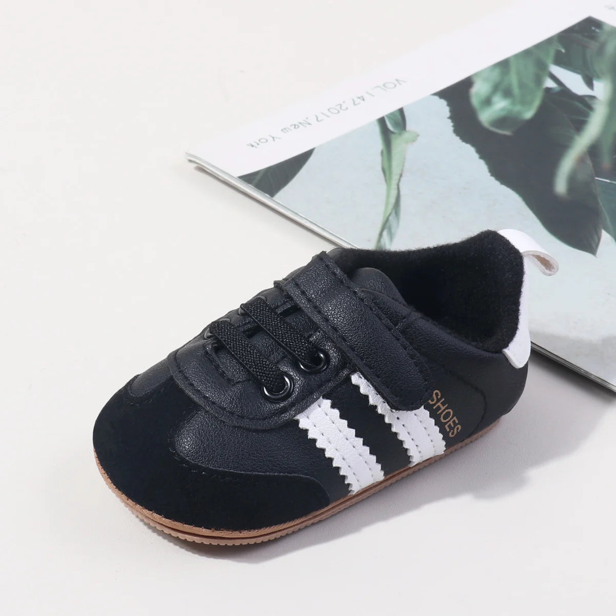 Baby first walker sneaker, dark navy upper with white side stripes and brown rubber sole