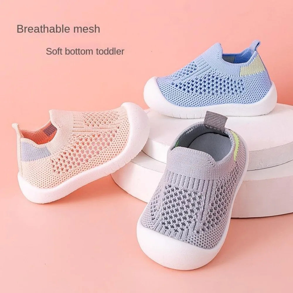 Toddler mesh slip-on sandals in blue, gray, and light pink on cushioned soles