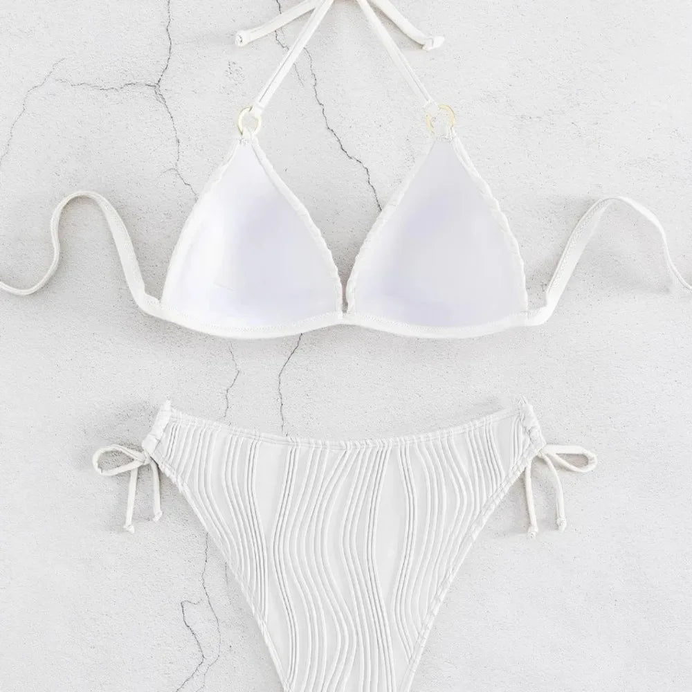 White ribbed triangle bikini top and matching tie-side briefs laid flat