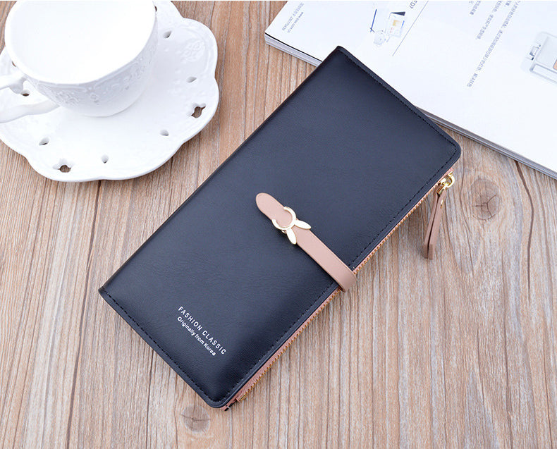 Long wallet purse, dark black with flap and bow clasp, gold zipper detail