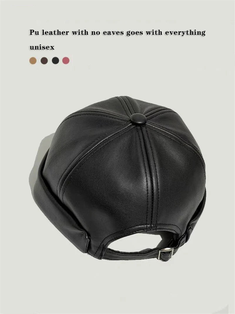 Black PU leather docker cap, round crown with stitched center seam and top button.