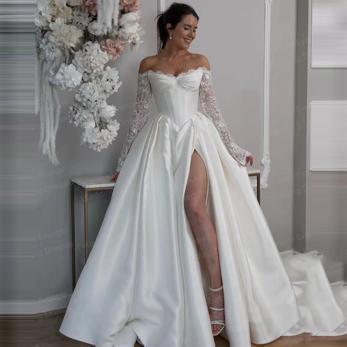 Off-shoulder sequined bridal gown with long lace sleeves and side slit skirt