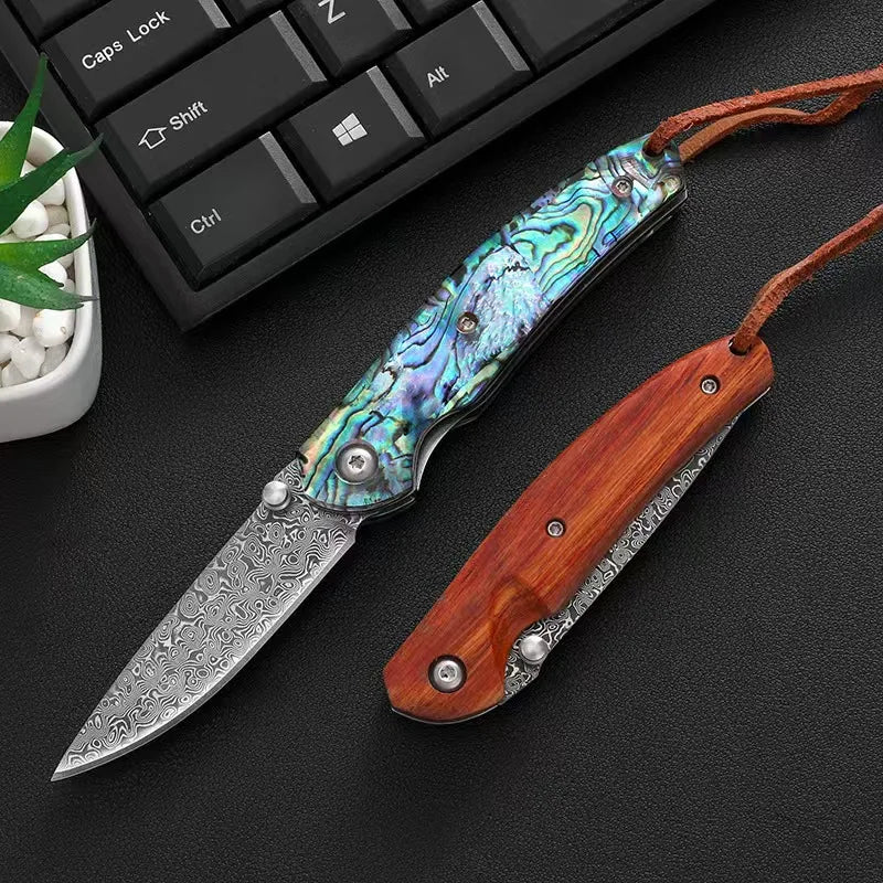Damascus steel folding knife with colorful iridescent blue handle and silver blade