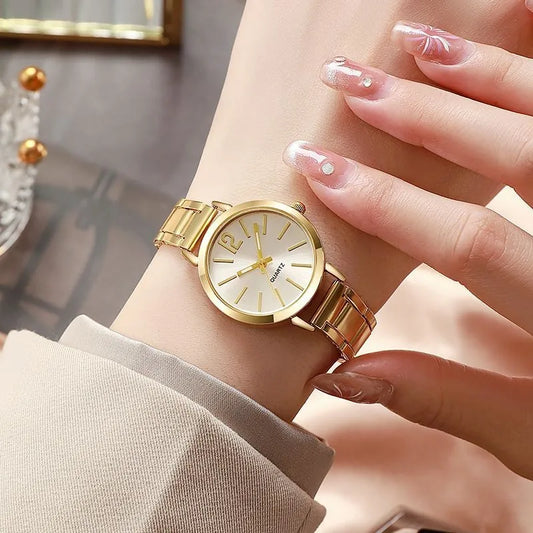 Women's quartz wristwatch with gold circular dial and link bracelet, minimalist markers.