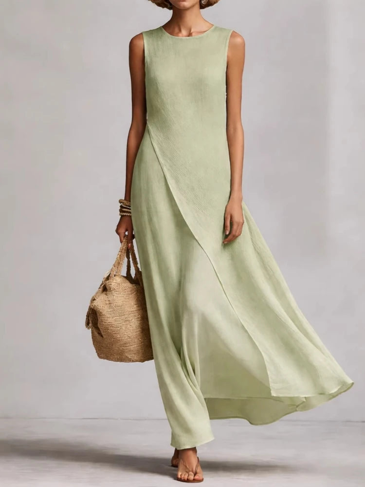 Light sage green sleeveless maxi dress with draped front and flowing long skirt