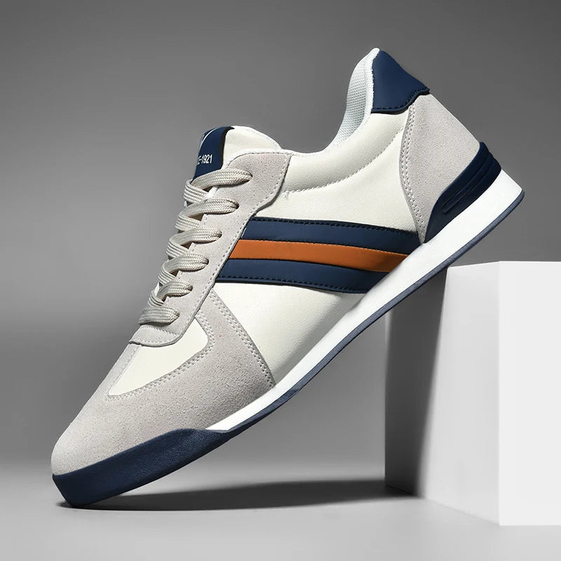 Retro sneakers in off-white/gray with navy accents and orange side stripe