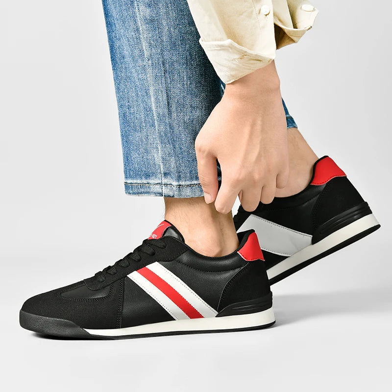 Retro sneakers in black with white side stripe and red heel accents, lace-up