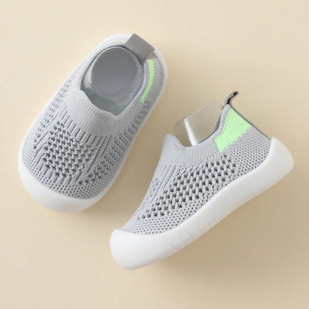Gray knit slip-on toddler sandals with neon green collar and white sole