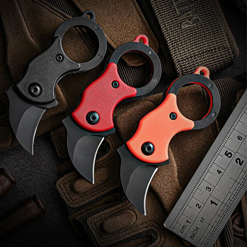 Mini folding pocket knives with keychain rings, red, orange, and black handles