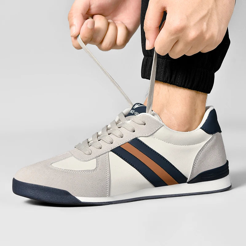 Retro lace-up sneakers in off-white/gray with navy accents and orange side stripe