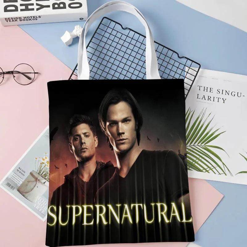 Black fabric tote bag with Supernatural portrait print and large "SUPERNATURAL" title