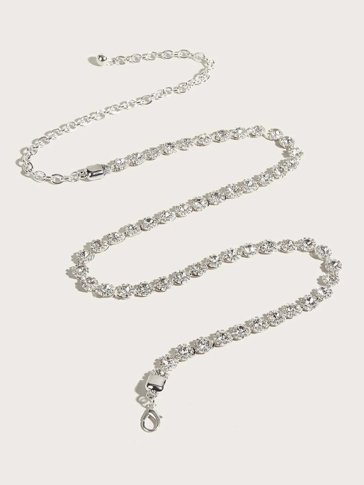 Silver rhinestone waist belt with extender chain and lobster clasp, laid out