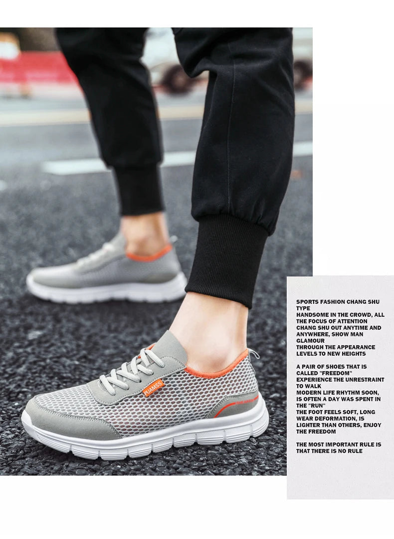 Gray mesh lace-up sneakers with orange accents and white cushioned sole