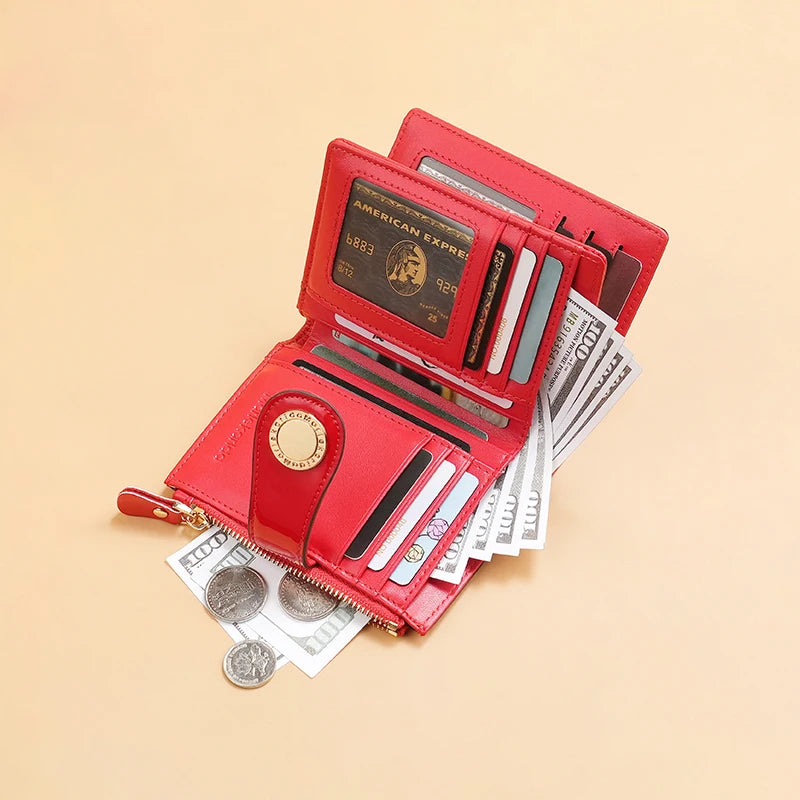 Red short wallet open with card slots, gold-tone zipper, and bills with coins