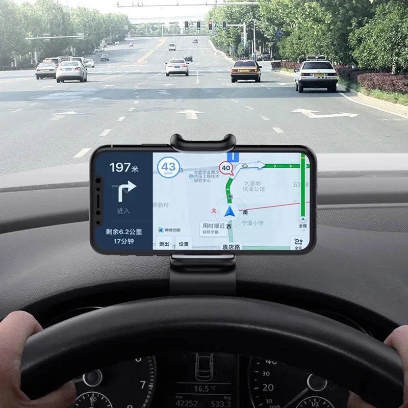 Black dash phone mount with smartphone displaying navigation in the vehicle