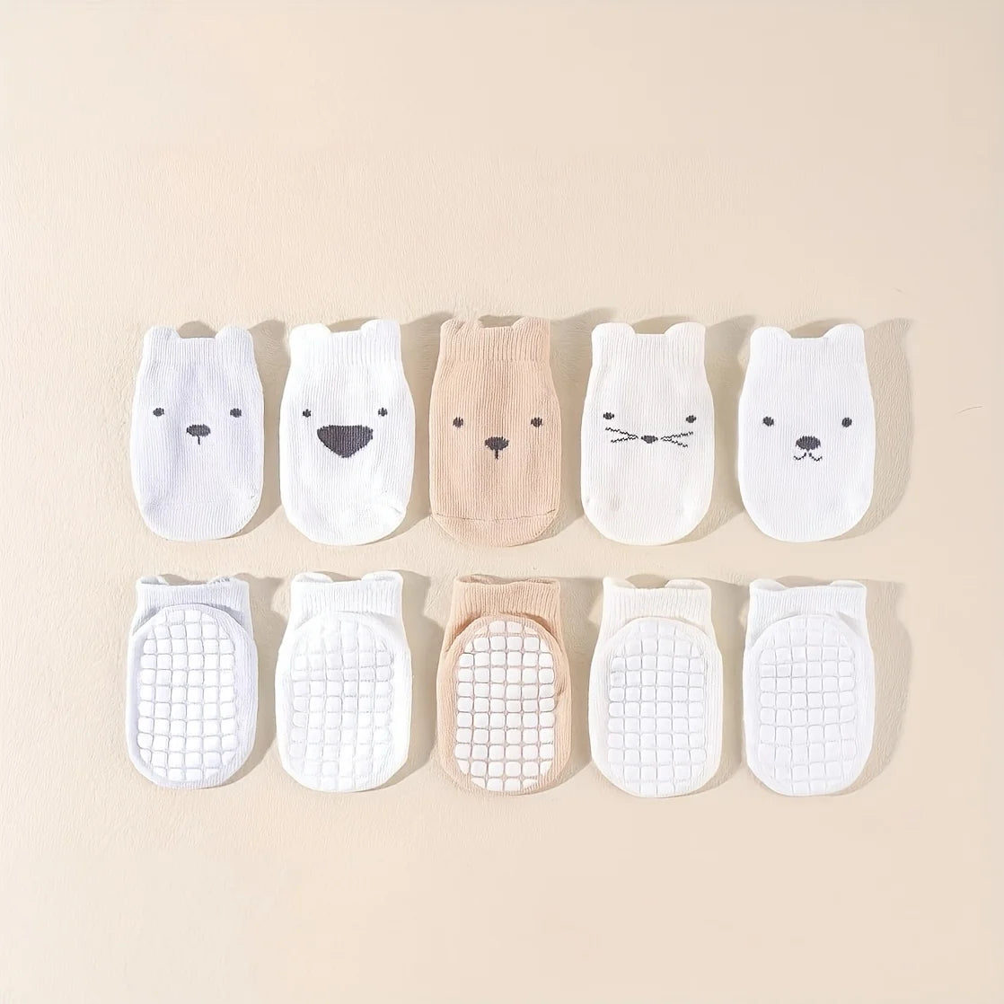 10-pack baby socks with animal prints and grippy mesh soles, mostly white and beige