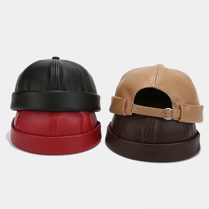 Unisex PU leather docker cap pair in black and tan with adjustable buckle straps