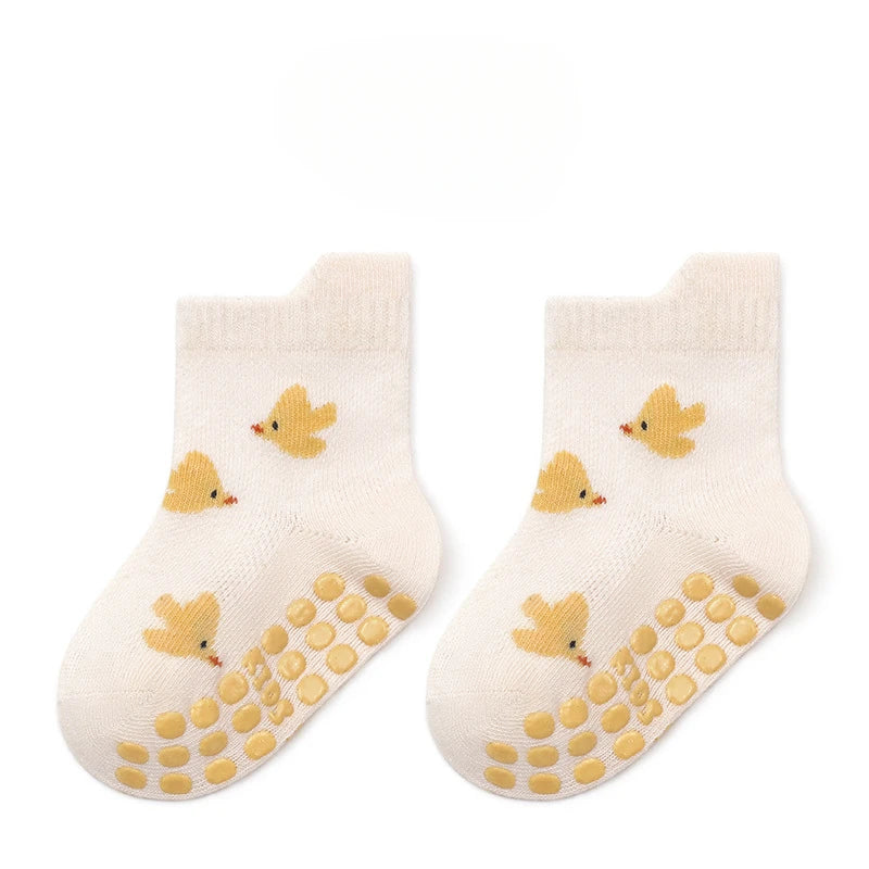 Pair of non-slip baby floor socks in cream with duck print and grippy dots
