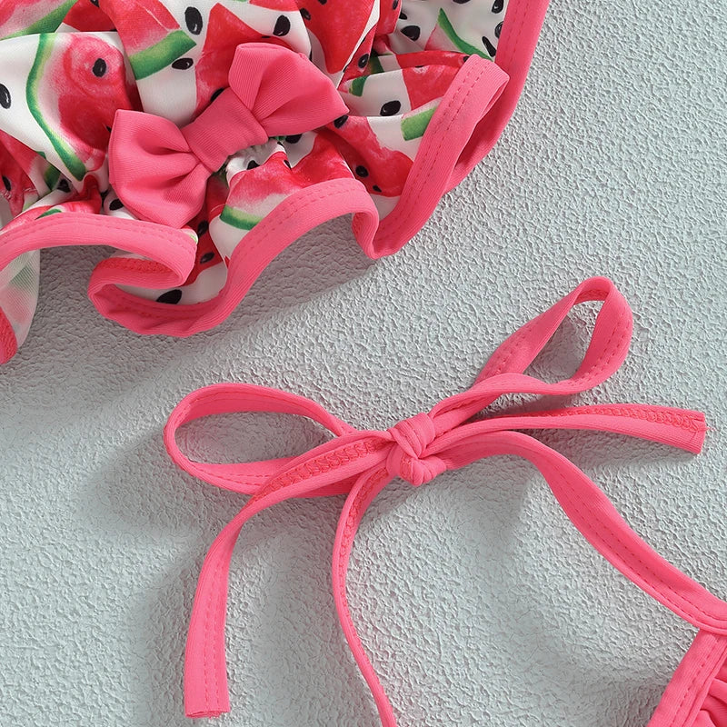 Pink ruffle swimwear top with tied halter straps and bikini bottoms close-up