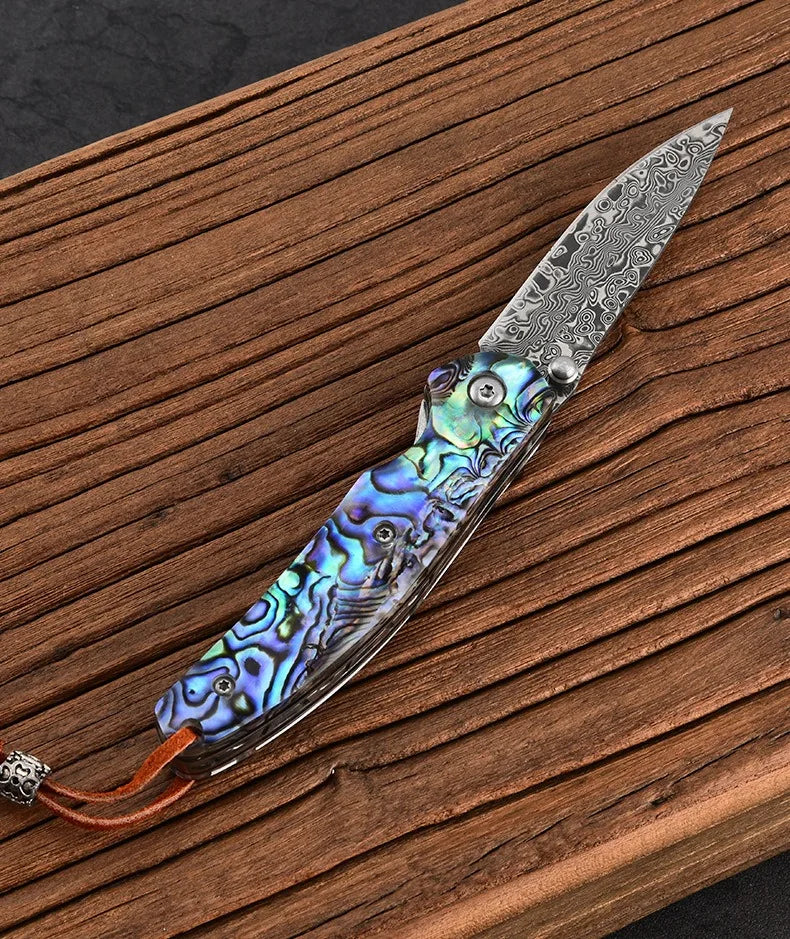 Damascus steel folding knife with iridescent blue handle and silver damascus blade