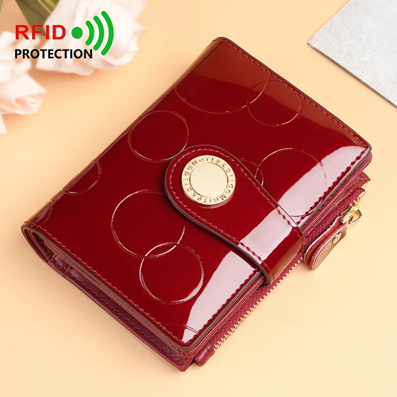Burgundy patent short wallet card holder with circular pattern, gold emblem and chain