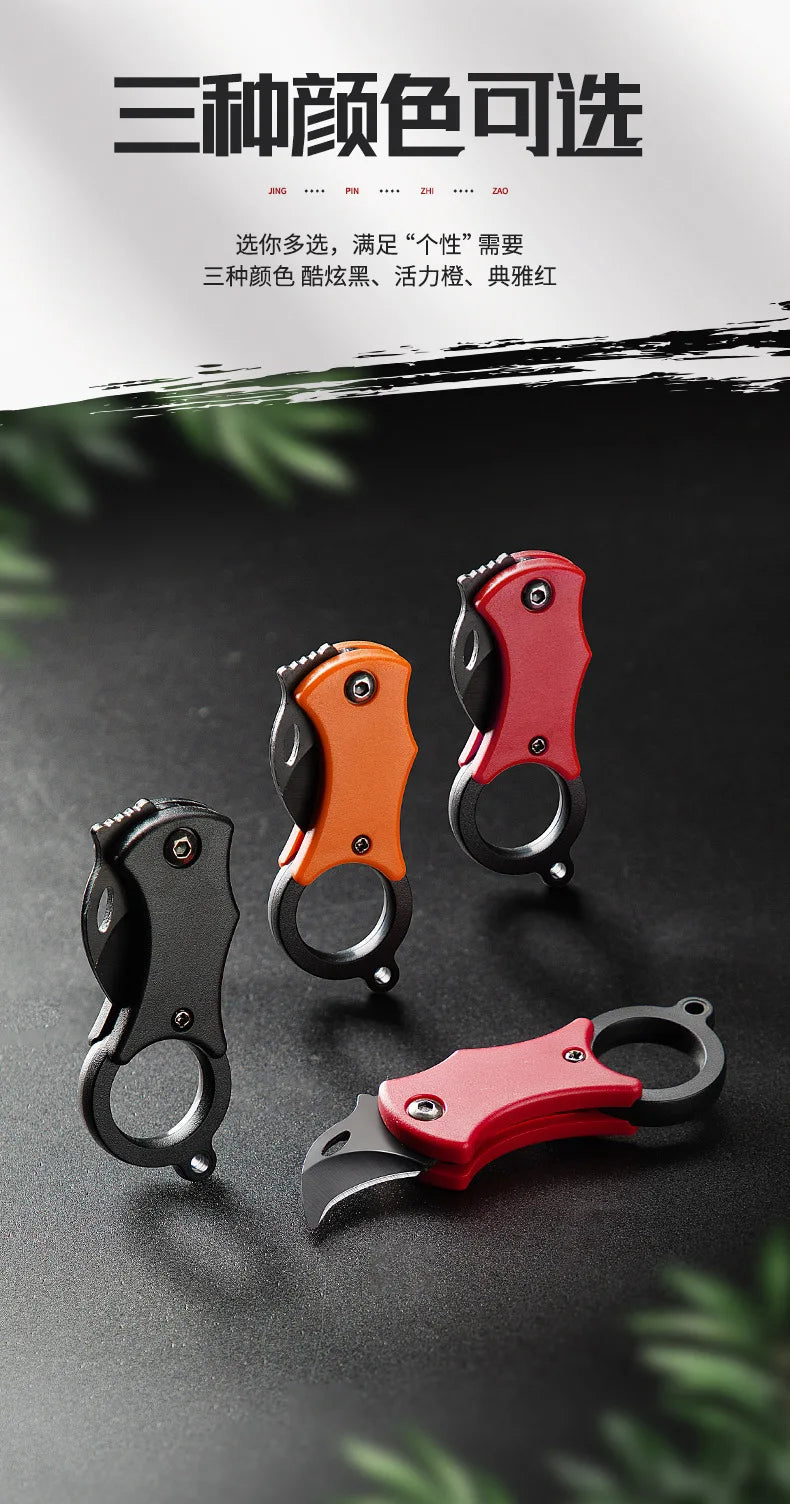 Assorted mini folding pocket knives with keychain rings in black, orange, and red