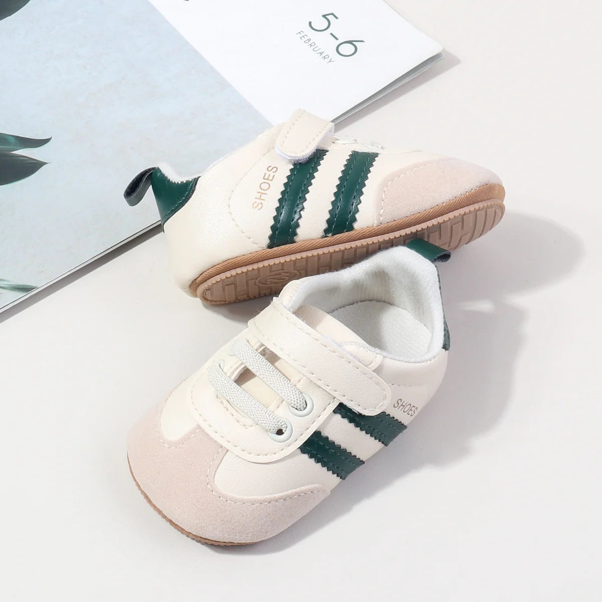 Baby first walker sneakers, white and apricot tones with green side stripes and brown sole